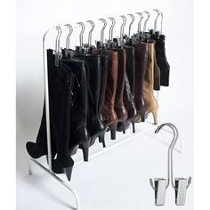 a rack with several pairs of boots hanging from it's sides and on the side