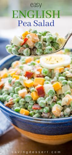 pea salad with eggs and bacon in a blue bowl on top of a wooden table