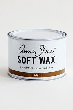 an open can of soft wax on a white surface