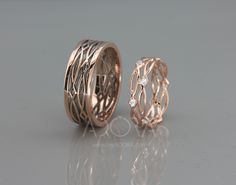 two gold wedding rings with diamond accents on each side, set in 18k rose gold