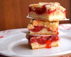 three pieces of cake sitting on top of a white plate