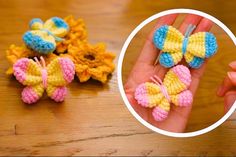 crocheted butterflies are being held by someone's hand