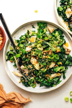 two white plates filled with green vegetables and nuts