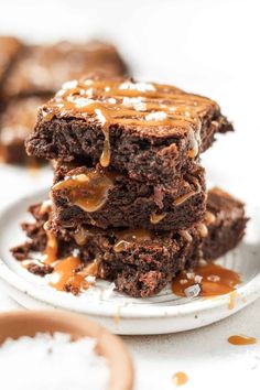 three brownies stacked on top of each other with caramel drizzle