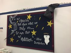 a chalk board with writing on it and umbrellas hanging from the ceiling in an office