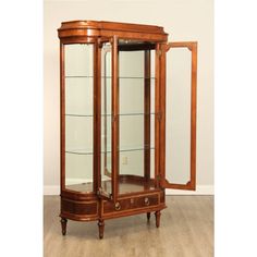 a wooden display case with glass doors and drawers on top of the cabinet is sitting on a hard wood floor