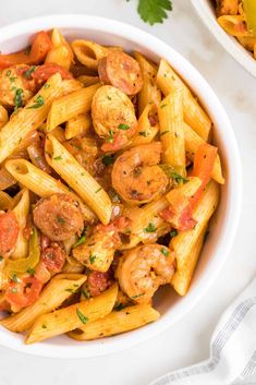 pasta with shrimp and tomato sauce in a white bowl