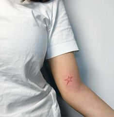 a woman with a small star tattoo on her arm