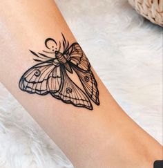 a small butterfly tattoo on the right arm and leg, it looks like an insect with wings