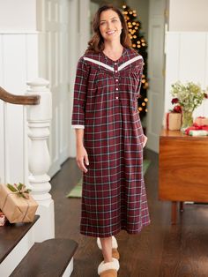 This lightweight flannel nightgown inspires cozy nights spent reading a book by the fire and sipping hot cocoa. The soft brushed cotton flannel and roomy fit leave you feeling comfy, and the pretty lace isn't the only detail you'll love! This flannel nightgown also features pintuck accents, a banded collar, 3/4 sleeves, and a rich plaid with a festive look, making this nightgown great for the holidays and beyond! Lightweight brushed flannel Longer length Beautiful red berry plaid with a pop of charcoal gray Classic Henley neckline Button placket Soft lace trim around neckline and cuffs 3/4 sleeves Horizontal pintucks Side-seam pockets Approx. 50" long 100% cotton Machine wash and dry Imported Exclusive to The Vermont Country Store Coordinating Ella Simone Lace and Plaid Cotton Flannel Paja Long Flannel, Flannel Nightgown, Vermont Country Store, Flannel Pajama Sets, Flannel Pajamas, Country Store, Sleepwear & Loungewear, Brushed Cotton, Cotton Flannel