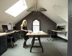 a woman standing at a table in an office