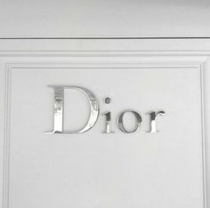 the word dior is cut out of metal