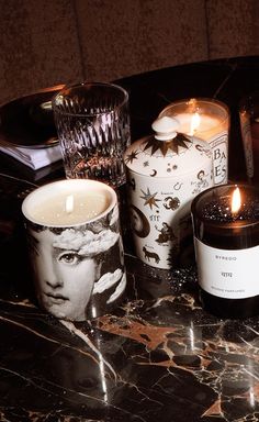 two candles sitting on top of a marble table