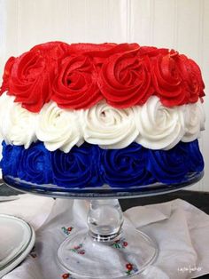 a cake with red, white and blue frosting on it sitting on a table