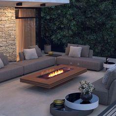 a living room with couches and a fire pit