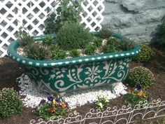 a large green planter sitting in the middle of a garden