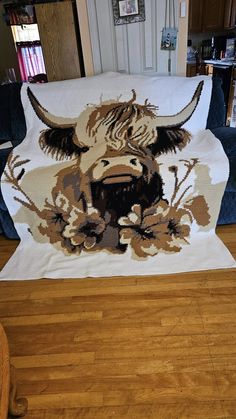 an animal is depicted on the back of a couch in a living room with wood flooring