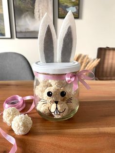 a jar filled with rice krispy treats and two bunny ears on top of it