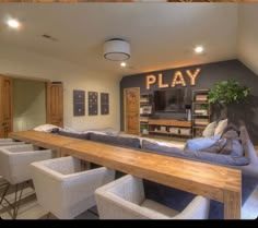 a living room filled with furniture and a flat screen tv sitting on top of a wooden table