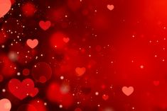 many hearts are floating in the air on a red and black background with sparkles