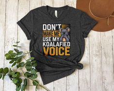 🐨 Embrace your inner humor with this funny koala T-Shirt! Perfect for animal lovers and those who love unique graphic tees, this shirt features a cute koala and the phrase "Don't Make Me Use My Koalafied Voice". Ideal for casual wear or as a gift for friends and family. Get yours today and showcase your koalafied style! 🐨 Product Features: Fabrication: 100% Airlume combed and ring-spun cotton, 32 single 4.2 oz. (Ash - 99% Airlume combed and ring-spun cotton, 1% poly) Seams: Side-seamed Fit: Re Funny Koala, Cute Koala, Use Me, Koala, Clothing Items, Animal Lover, Graphic Tee, The Voice, Spun Cotton