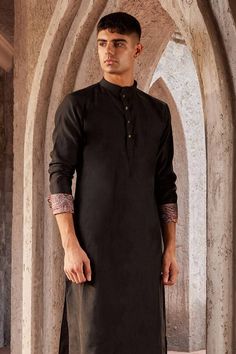 Black full sleeve kurta with paisley print on sleeve hem and mandarin collared neckline. Paired with churidar.
Components: 2
Pattern: Printed
Type Of Work: Paisley
Neckline: Mandarin collar
Sleeve Type: Full sleeves
Fabric: Chanderi, Voile, Lining: Voile
Color: Black
Other Details: 
Front button detailing
Note: Pocket square and bundi worn by the model is not for sale
Occasion: Destination Wedding - Aza Fashions Full Sleeve Kurta, Kurta Set For Men, Types Of Work, Churidar, Kurta Set, Plain Black, Full Sleeves, Mandarin Collar, Pocket Square