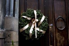 a wreath is hanging on the front door