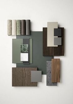 an assortment of different materials are arranged on a white wall with grey and brown accents