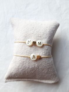 This bracelet mounted on braided nylon thread is made up of 8mm mother-of-pearl letter bead(s) (one or two initials of your choice), as well as a 5mm fine gold-plated brass heart and 925 silver beads gilded with fine gold of 4mm. The bracelet is adjustable (between approximately 15cm and 19cm) thanks to the sliding knot and fits the wrist! Please note: mother-of-pearl is natural, there is a possibility of having nuances. Each pearl is unique and may have imperfections. Properties of Mother-of-Pe Adjustable Heart Beads Pearl Bracelet, Adjustable Pearl Bracelet With Heart Beads, Gold Beaded Bracelet For Valentine's Day Personalized Gift, Personalized Gold Beaded Bracelet For Valentine's Day, Gift Pearl Bracelet With Heart Beads, Adjustable Gold Heart Bracelet With Letter Beads, Handmade Cream Pearl Bracelet Gift, Gold Heart-shaped Name Bracelet With Letter Beads, Adjustable Pearl Bracelet With Letter Beads As A Gift