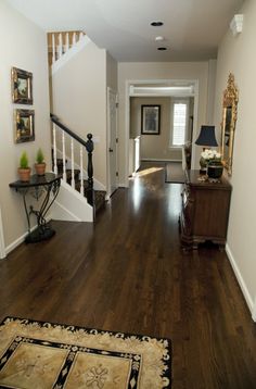 a hallway with hardwood floors and white walls