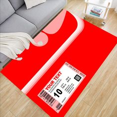 a red area rug with a ticket on it in the middle of a living room