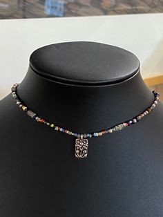 "Made to order with your specifications, can use current Mix or request different colors. Fill out personalization or message me. Small BOHO unisex choker with pewter floral pendant. Beads are all approx 2-3 mm. Exclusive MaRV bead mix includes labradorite, ancient beads from Mali, & Ghana glass beads. Small toggle clasp. Great stocking stuffer! 15\" If you would like an extension added just let me know. Free gift of the month and free shipping for purchases over $35. Exclusive Studio design All Silver Beaded Necklace With Flower Pendant As Gift, Adjustable Silver Choker With Colorful Beads, Silver Adjustable Choker With Colorful Beads, Silver Choker With Colorful Beads, Adjustable, Silver Choker With Colorful Beads As Gift, Silver Choker With Colorful Beads For Gift, Ancient Beads, Small Boho, Floral Pendant