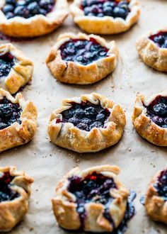 blueberry pies are arranged on a baking sheet