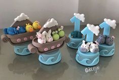 there are three toy boats with animals in them