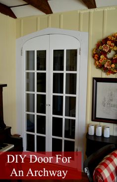 a living room with an arch door and piano