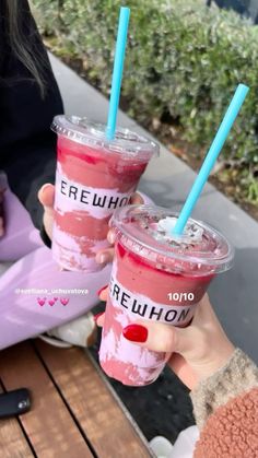 two people holding up drinks in their hands