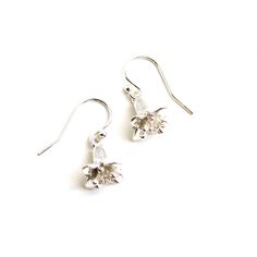 These dainty floral earrings are inspired by the flowers of the model plant Arabidopsis thaliana. Arabidopsis is a useful model organism for plant biologists. Following the flower anatomy of the Brassicaceae, Arabidopsis flowers have four petals alternating with four sepals, and six stamens (four longer and two shorter) surrounding the pistil. The individual flowers of the earrings are 1.1 cm (0.4 inches) below the loop and have a diameter of 1.2 cm (0.5 inches). The earrings are available in so Sterling Silver Birth Flower Earrings, Delicate Sterling Silver Flower Earrings With Ear Wire, Silver Dangle Earrings With Birth Flower, Delicate Sterling Silver Birth Flower Earrings, Sterling Silver Birth Flower Drop Earrings, Sterling Silver Birth Flower Earrings For Wedding, Nature-inspired Flower Sterling Silver Earrings, Sterling Silver Drop Earrings With Birth Flower, Dainty Sterling Silver Birth Flower Earrings