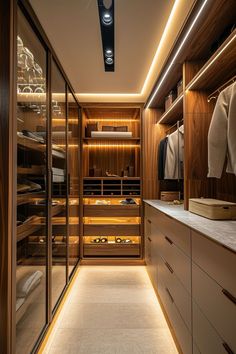 a walk - in closet with lots of drawers and lights on the ceiling is lit by recessed lighting