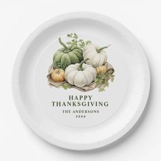 a white plate with pumpkins and leaves on it that says happy thanksgiving the andersons