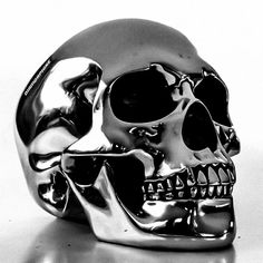 a silver skull sitting on top of a table