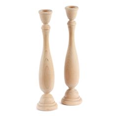 two wooden candlesticks sitting next to each other