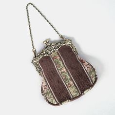 Introducing our captivating collection of Chatelaine purses, inspired by the elegance of the Victorian era.Available in three sizes—Large, Medium, and Small—these purses offer versatility and style. The Large and Medium sizes can be used as both a clutch and a crossbody purse, as we provide two chains for each size: 50" and 13" in length. This allows you to effortlessly switch between crossbody and clutch styles.Let's focus on the Chatelaine Large Crossbody Purse:With a frame width of 6.25" and a height of 8", this purse comfortably holds larger items like the iPhone 14 Pro Max and a passport. It features a small slip pocket for cards or small essentials, and the 1.5" bottom depth provides ample space for your necessities.The Large Crossbody Purse includes two chains, each with brass hooks Elegant Brown Coin Purse, Vintage Brown Pouch Evening Bag, Elegant Brown Rectangular Coin Purse, Elegant Rectangular Coin Purse, Elegant Rectangular Coin Purse For Daily Use, Elegant Rectangular Travel Coin Purse, Vintage Brown Coin Purse With Removable Pouch, Formal Brown Coin Purse With Removable Pouch, Victorian Pouch Bags As Gifts