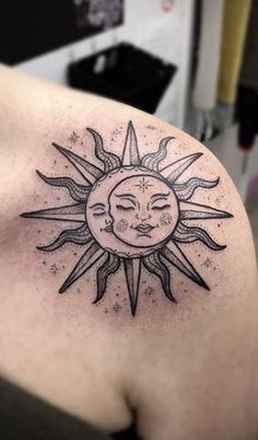 a sun and moon tattoo on the shoulder