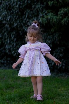 Our Patchwork Dress perfectly blends comfort and style. It combines different patterns, resulting in a romantic and unique dress. Crafted from soft, breathable, 100% cotton fabric, it ensures your child stays comfortable all day, whether they are attending a family gathering, a birthday party, or simply enjoying a day out.  The circle skirt allows for movement, perfect for twirling and dancing, while the soft shirring defines the waist for a perfect fit, without compromising comfort. The hem, go Cute Puff Sleeve Dress With Smocked Bodice, Spring Dress With Smocked Bodice For Playdate, Cute Summer Dresses With Balloon Sleeves, Cute Balloon Sleeve Summer Dresses, Cute Fitted Dress With Balloon Sleeves, Cute Puff Sleeve Dress With Ruffles For Garden Party, Cute Puff Sleeve Dress With Gathered Sleeves For Spring, Cute Puff Sleeve Dress With Gathered Sleeves, Cotton Dresses With Balloon Sleeves