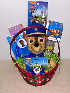 a teddy bear in a basket with toys