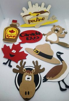 paper cutouts with different types of hats and animals on them, including maple leaves