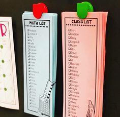 three pink and blue paper clipboards with writing on them, each one has a math list attached to it