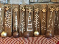 wooden christmas decorations are lined up on a table