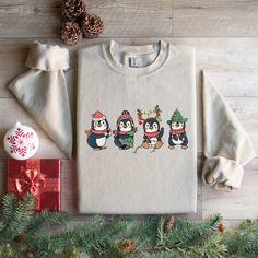 Christmas Penguin Sweatshirt, Cute Penguin Merry Christmas Shirt, Christmas Penguin Lover Shirt, Winter Xmas Sweatshirt, Cute Christmas Gifts IMPORTANT : Price includes one sided print. Double sided print (front and back) costs extra $6. You can add your order 'CUSTOM PRINT' from Custom Section. HOW TO ORDER SHIRT 1) Select Your T-Shirt Size and Color from the drop down menus. 2) Choose Your Quantity 3) Click ADD TO CART 4) Click "Proceed to Check Out"  If you want to have 3xl or 4xl, please send us a message. - If you want to have another color that is not listed, tank top, youth sweatshirt, or youth hoodie please send us a message. Product We sell Bella Canvas, Gildan soft style, and Circle Soft Style shirts, sweatshirts, and hoodies. IF YOU WANT TO HAVE A SPECIFIC BRAND, PLEASE LET US K Cute Winter T-shirt For Gift, Christmas Gift Cotton Sweater, Penguin Sweatshirt, Cute Penguin, Cute Christmas Gifts, Merry Christmas Shirts, Sweatshirt Cute, Christmas Penguin, Cute Penguins