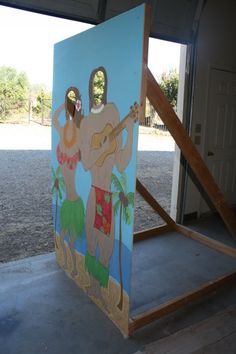 a painting on the side of a building with a man and woman playing guitar in front of it